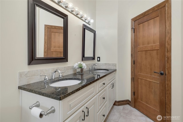 bathroom featuring a sink and double vanity