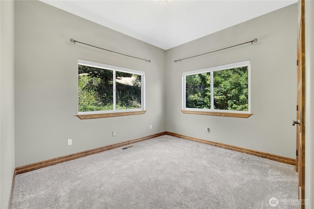 empty room with baseboards, carpet, and visible vents