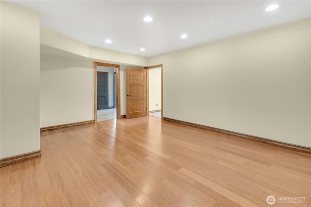 spare room featuring recessed lighting, baseboards, and light wood-style flooring