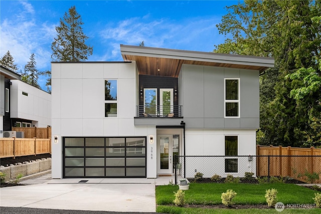 3968 162nd Pl SE, Bellevue, WA 98006 - contemporary house with a balcony, fence, concrete driveway, and an attached garage