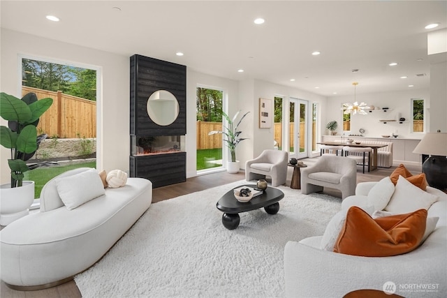 3968 162nd Pl SE, Bellevue, WA 98006 - living room with wood finished floors, recessed lighting, healthy amount of natural light, a chandelier, and a fireplace