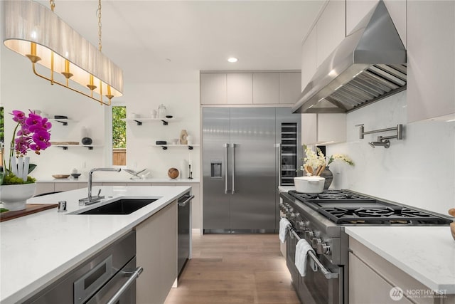 3968 162nd Pl SE, Bellevue, WA 98006 - kitchen with wall chimney range hood, high end appliances, a sink, recessed lighting, and modern cabinets