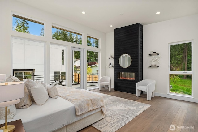 3968 162nd Pl SE, Bellevue, WA 98006 - bedroom featuring a fireplace, wood finished floors, recessed lighting, access to outside, and baseboards