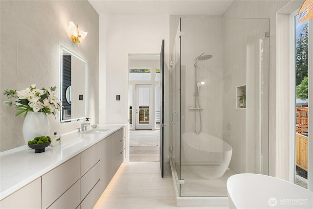 3968 162nd Pl SE, Bellevue, WA 98006 - full bathroom with a shower stall, a freestanding bath, vanity, and wood finished floors