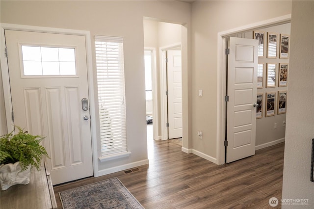 entryway with baseboards and dark wood finished floors