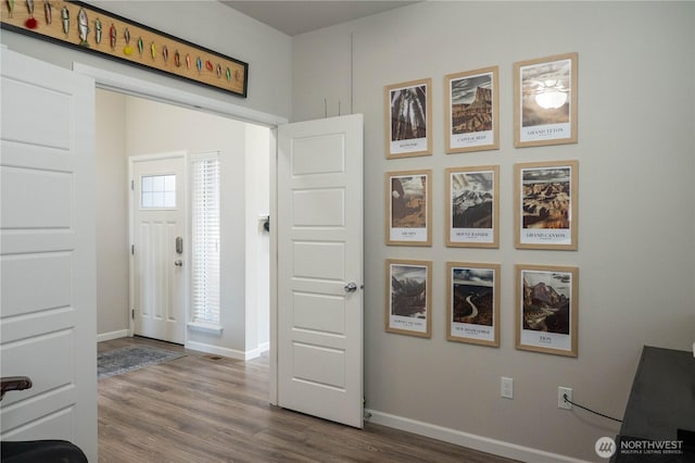 entryway with dark wood-style flooring and baseboards