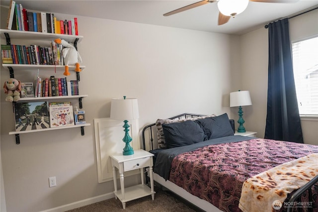 carpeted bedroom featuring a ceiling fan, baseboards, and multiple windows
