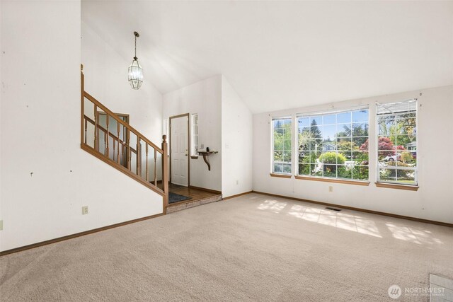 unfurnished living room featuring carpet floors, baseboards, stairs, and visible vents