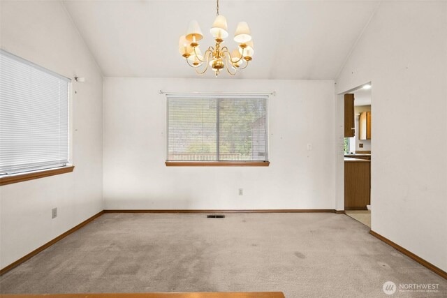 unfurnished room with visible vents, baseboards, light colored carpet, a chandelier, and vaulted ceiling