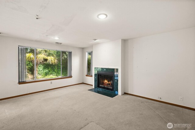 unfurnished living room with carpet floors and baseboards