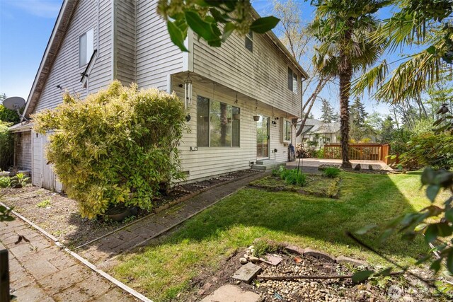 view of side of property featuring a yard