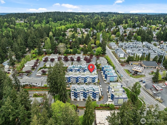bird's eye view with a wooded view