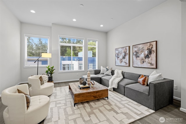 living area with recessed lighting, baseboards, and wood finished floors