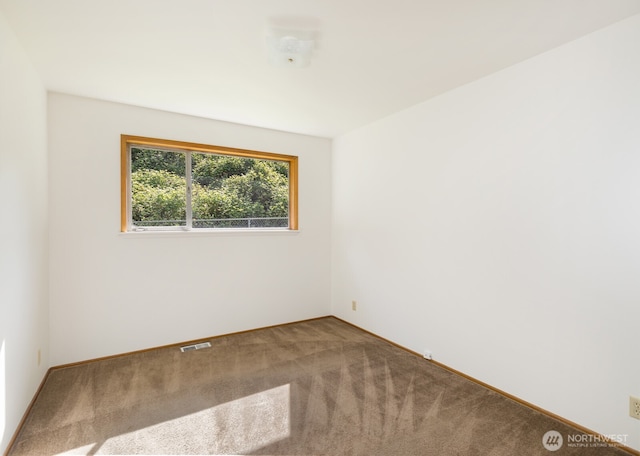 carpeted empty room with baseboards and visible vents