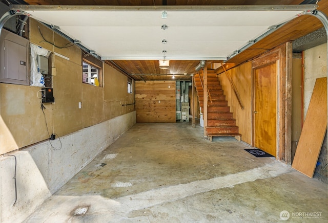 below grade area with a garage, stairs, and electric panel