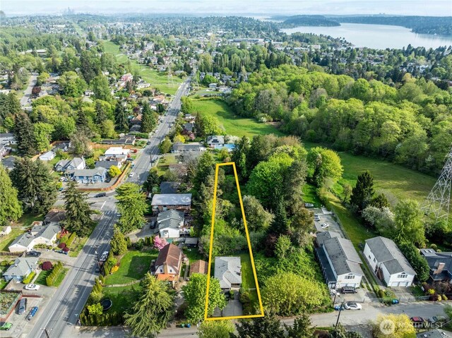 drone / aerial view featuring a water view and a residential view