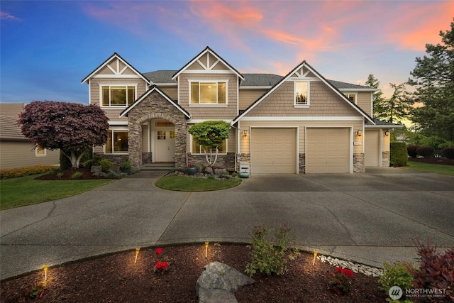 craftsman-style house featuring driveway and stone siding