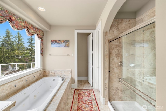 bathroom featuring a tub with jets, recessed lighting, and a shower stall
