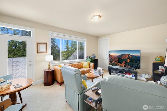 carpeted living room featuring plenty of natural light and baseboards