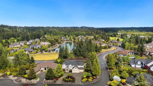 birds eye view of property with a residential view, a water view, and a forest view