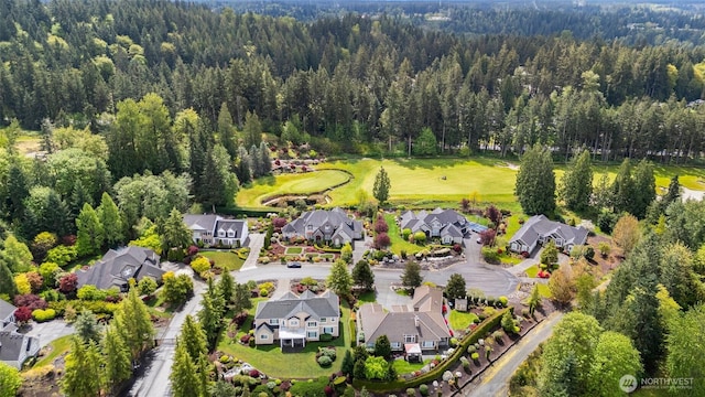 birds eye view of property featuring a view of trees and a residential view