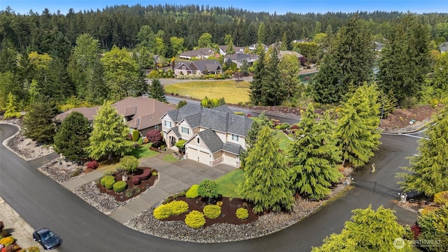 birds eye view of property featuring a residential view and a view of trees