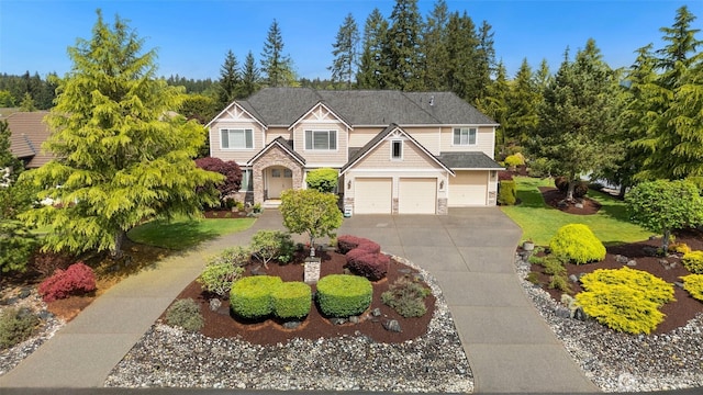 view of front facade featuring a garage, a front yard, stone siding, and concrete driveway