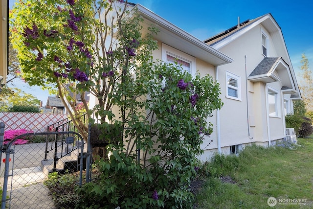 view of home's exterior featuring fence and stucco siding