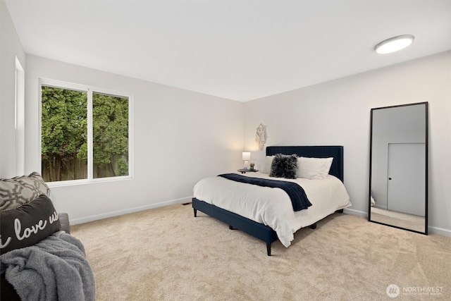 carpeted bedroom featuring baseboards