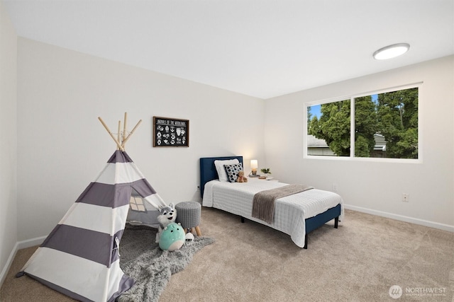 carpeted bedroom featuring baseboards