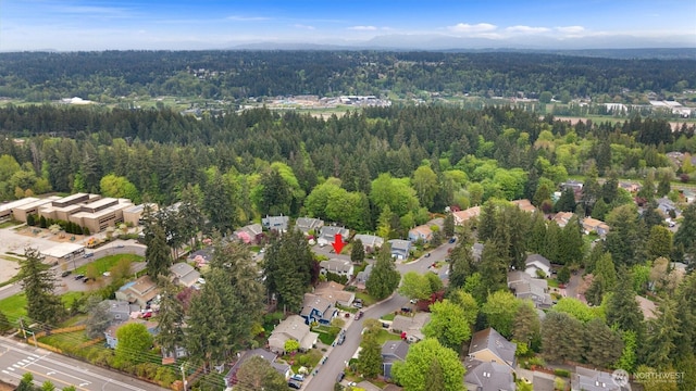 birds eye view of property featuring a residential view and a view of trees