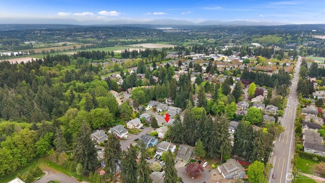 drone / aerial view featuring a residential view and a mountain view
