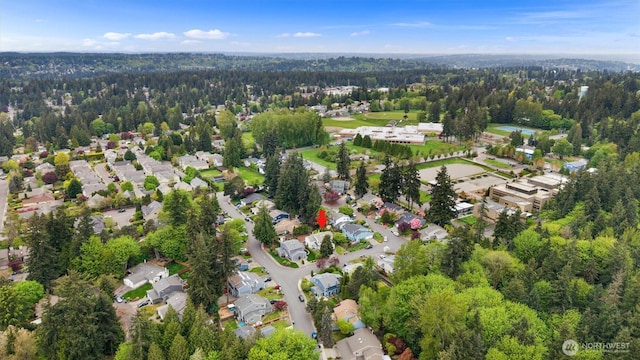 drone / aerial view with a view of trees and a residential view