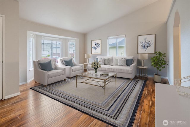 living room with baseboards, vaulted ceiling, and wood finished floors