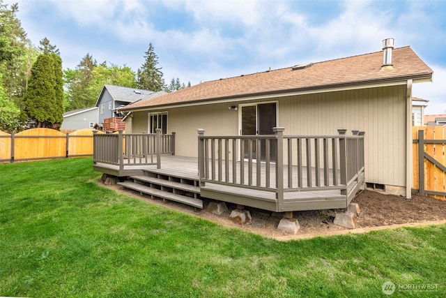 back of house featuring a fenced backyard, roof with shingles, a yard, and a deck