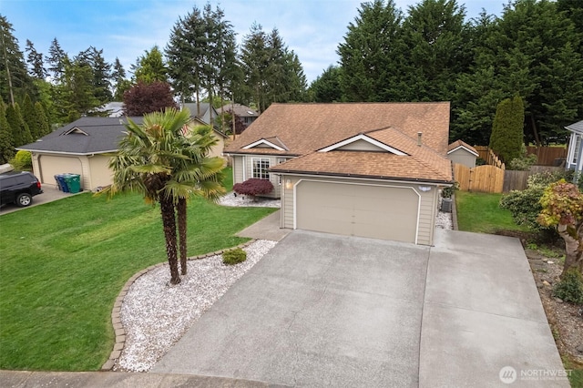 view of front of property featuring fence, a shingled roof, a front lawn, a garage, and driveway