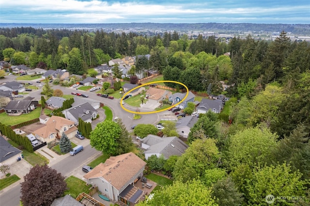 birds eye view of property with a residential view and a wooded view