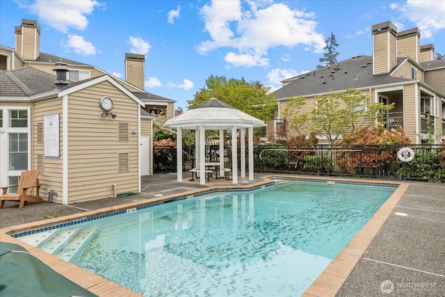 pool with fence and a gazebo