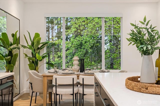 dining space with plenty of natural light and light wood finished floors