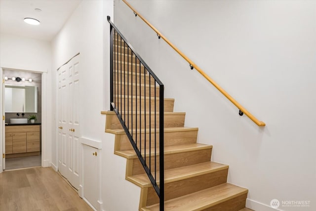 stairway with baseboards and wood finished floors