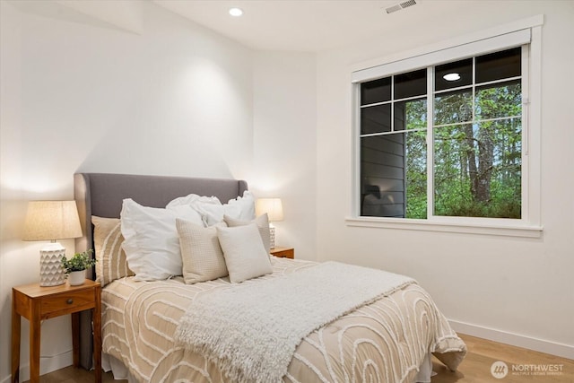 bedroom with recessed lighting, baseboards, visible vents, and wood finished floors