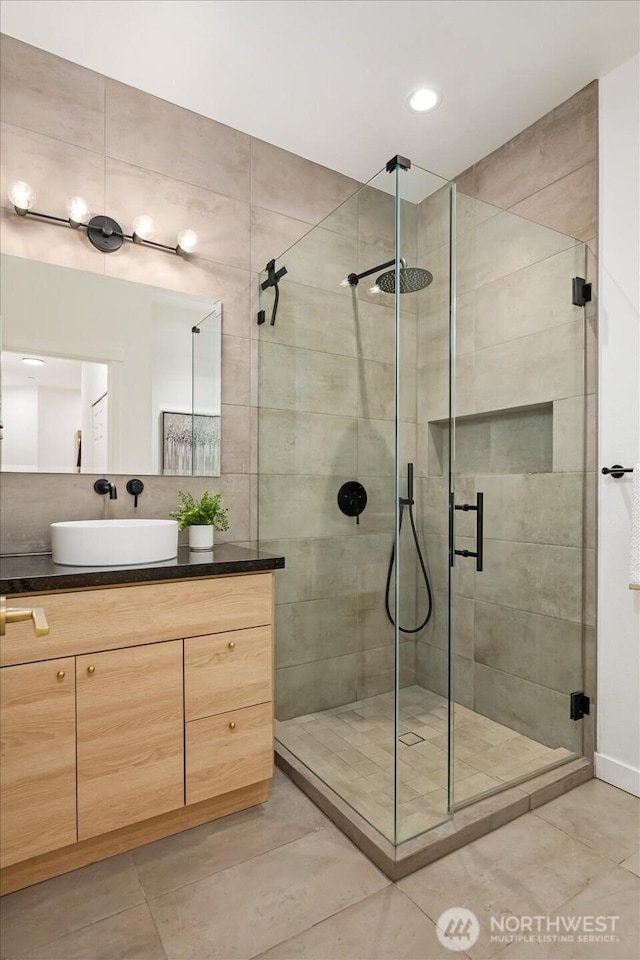 bathroom with recessed lighting, tile patterned floors, a shower stall, and vanity