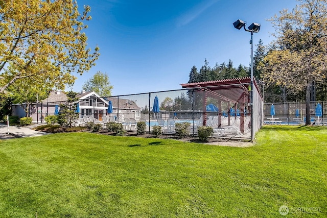 exterior space featuring fence and a lawn