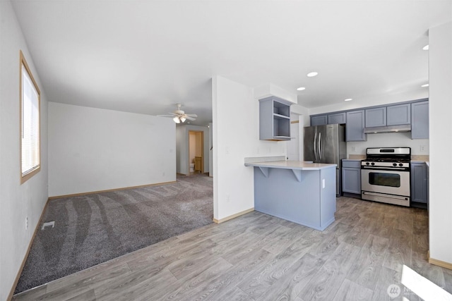1507 Fruitland Dr, Bellingham, WA 98226 - kitchen with stainless steel appliances, under cabinet range hood, open shelves, light countertops, and a peninsula
