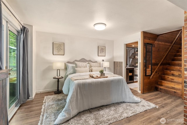 bedroom featuring baseboards and wood finished floors