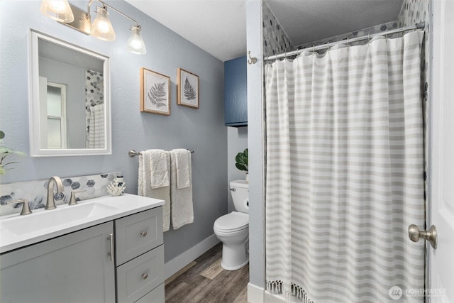 full bath featuring vanity, curtained shower, toilet, and wood finished floors