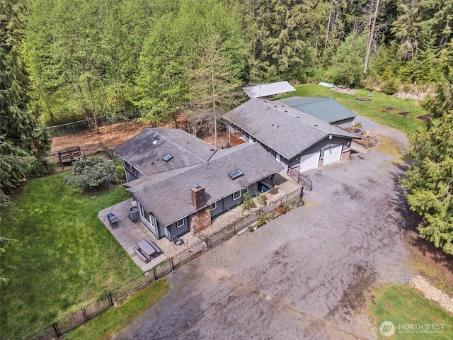 birds eye view of property featuring a view of trees