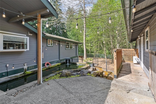 view of property exterior with fence and a wooden deck