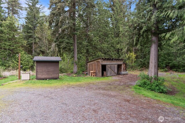 view of shed featuring a forest view