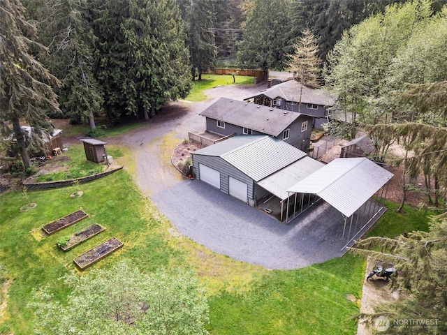 birds eye view of property with a view of trees